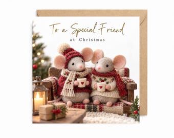 May include: A square greeting card featuring two felted mice sitting on a small wooden bench, holding tiny mugs. The mice wear knitted sweaters, scarves, and hats. The text reads To a Special Friend at Christmas in gold and black script.