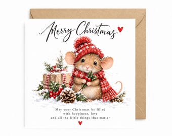 May include: A square greeting card featuring a brown mouse wearing a red knit hat and scarf, holding holly berries. The text reads Merry Christmas and May your Christmas be filled with happiness, love and all the little things that matter.