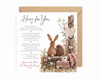 May include: A square greeting card with a brown envelope featuring a brown rabbit and a hedgehog sitting together. The card includes the text Here for You, a poem about support, and the phrase You're never alone I'm always here for you.