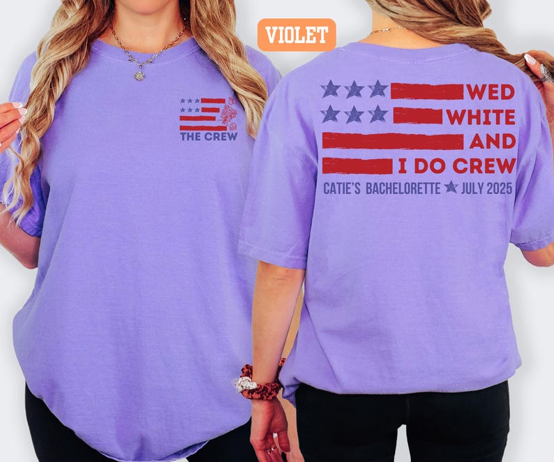 May include: A violet short-sleeved t-shirt with a graphic design on the front and back. The front features a flag design with the text "THE CREW". The back displays a flag design with the text "WED WHITE AND I DO CREW CATIE'S BACHELORETTE JULY 2025".