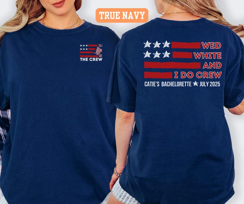 May include: Navy blue t-shirts with a patriotic design. The front of the shirt says "THE CREW" with an American flag graphic. The back of the shirt says "WED WHITE AND I DO CREW CATIE'S BACHELORETTE JULY 2025".