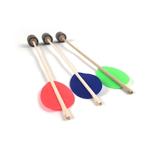 May include: Three toy arrows with wooden shafts, black rubber tips, and colorful fletching. The fletching is red, blue, and green. The arrows are arranged diagonally against a white background.