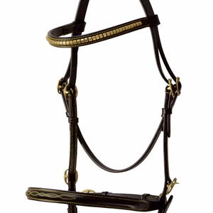 May include: A brown leather horse bridle with gold accents. The bridle has a browband with a decorative pattern of gold studs. The noseband and throatlatch are also decorated with gold stitching.