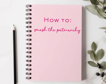 May include: Pink spiral bound notebook with the text "How to: smash the patriarchy" written in pink.