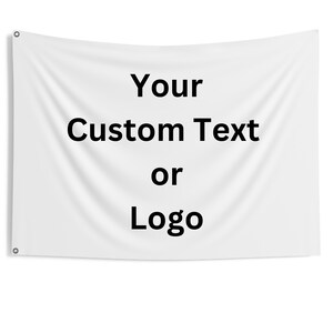 May include: White banner with the text "Your Custom Text or Logo" in black. The banner has grommets in the corners for hanging. The fabric has a slight texture and folds.