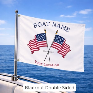 May include: A white rectangular boat flag attached to a metal pole, featuring two crossed American flags in the center. The text BOAT NAME is printed in blue above the flags, while Since 2025 and the red text Your Location appear below.
