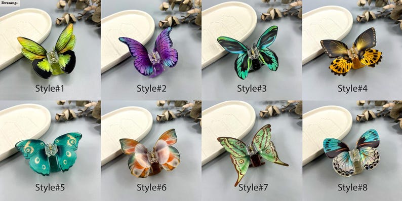 May include: Eight butterfly hair clips in a range of colours, such as green, purple, and yellow. Each clip has a detailed butterfly design with a central jewel. The clips are presented on a neutral background.