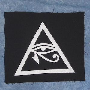 May include: A white all-seeing eye inside a white triangle on a black background. The eye is stylized with an eyebrow and a curved line below it.