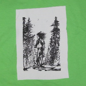 May include: Black and white illustration of a person riding a bicycle through a forest. The person is wearing a long-sleeved shirt and pants. The trees are tall and slender, with branches reaching up towards the sky.