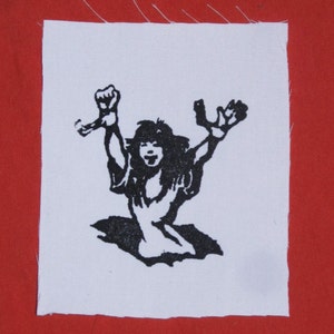 May include: Black and white iron-on patch featuring a silhouette of a person with arms raised in the air.