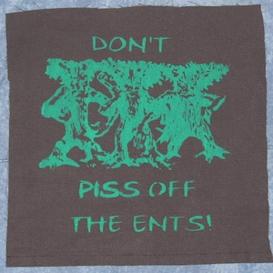 May include: A black fabric patch with green text and a green image of three tree-like figures. The text reads "Don't Piss Off The Ents!"
