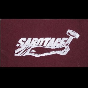 May include: White embroidered logo on a maroon background. The logo features a hand holding a hammer, with the word "SARTAGE" written above the hand.