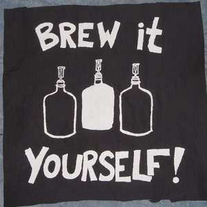 May include: Black fabric with white text that reads "Brew it yourself!" and three white outlined illustrations of bottles with stoppers.