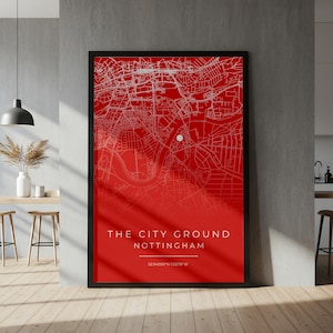 May include: Framed red map print of Nottingham's City Ground stadium. The map features white street details and a white marker. The text "THE CITY GROUND NOTTINGHAM" is displayed in white, along with the coordinates 52.94000°N 1.13278°W.