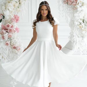 Classic milk white midi dress with short lantern sleeves, fitted bodice and sun flare skirt for weddings and special occasions