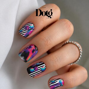 May include: Nail art featuring a black and white horizontal striped pattern accented with vibrant, multi-colored spheres and abstract flame-like designs in shades of pink, orange, and blue. The design is applied to four fingernails.