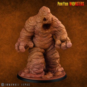 May include: A detailed, brown monster figurine with a textured, rocky appearance. The figure has a large open mouth, small eyes, and large hands. The base is black, and the text "PrintYourMonsters" is in the upper right corner.