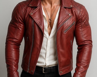 May include: A burgundy leather jacket with a quilted shoulder design, a notched collar, and a diagonal zipper closure. The jacket has a classic biker style with a tailored fit. The model is wearing a white shirt and black pants.
