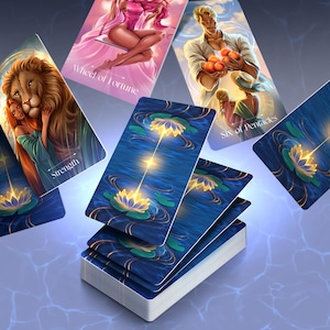 May include: A deck of tarot cards with illustrations of figures and symbols. The cards feature images of a woman on a swing, a man holding oranges, a lion, and a lotus flower. The cards are blue with gold accents and are arranged on a blue surface.