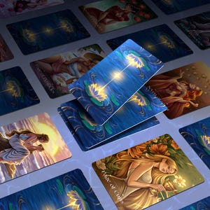 May include: A selection of tarot cards with detailed illustrations. The cards depict women, water lilies, and celestial themes. The dominant colours are blue, gold, and white. Some cards display text, such as "Page of Cups" and "Star of Pentacles."
