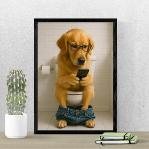 May include: A framed print featuring a golden retriever wearing glasses and denim shorts, sitting on a toilet while looking at a smartphone. The background includes a white tiled wall and a roll of toilet paper.