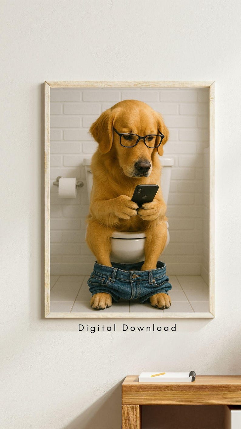 May include: A framed print featuring a golden retriever wearing glasses and denim shorts, sitting on a toilet while looking at a smartphone. The background is a white brick wall. Text at the bottom reads "Digital Download".