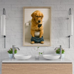 May include: A framed print shows a golden retriever wearing glasses and denim shorts, sitting on a toilet while looking at a smartphone. The dog is in a bathroom setting with a white brick wall.
