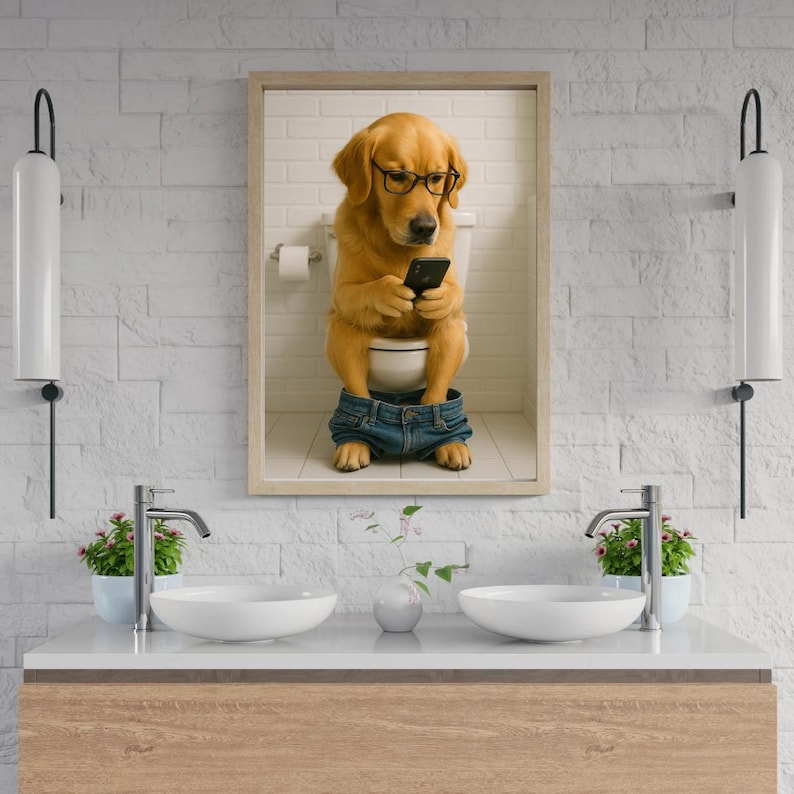 May include: A framed print shows a golden retriever wearing glasses and denim shorts, sitting on a toilet while looking at a smartphone. The dog is in a bathroom setting with a white brick wall.