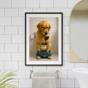 May include: Framed print of a Golden Retriever wearing glasses and jeans, sitting on a toilet while looking at a smartphone. The dog is in a bathroom setting with a white toilet, a roll of toilet paper, and a brick wall.