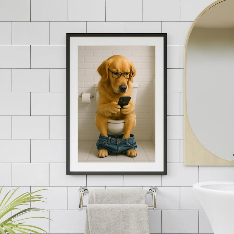 May include: Framed print of a Golden Retriever wearing glasses and jeans, sitting on a toilet while looking at a smartphone. The dog is in a bathroom setting with a white toilet, a roll of toilet paper, and a brick wall.