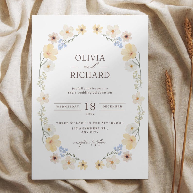 May include: A wedding invitation with floral accents. The invitation features the names "OLIVIA and RICHARD" and the date "18 DECEMBER 2027". The invitation is decorated with a floral border of yellow and blue flowers.