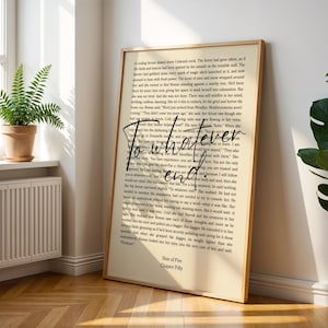 May include: A framed print with a light beige background featuring printed text and the words "To whatever end" in a handwritten style. The frame is a light brown colour. The print is leaning against a white wall.