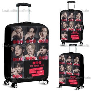 May include: Black rolling suitcase featuring a collage of portraits and the text "BTS WORLD TOUR" in red and white. The suitcase has a retractable handle and four wheels. The design includes the names of the band members.