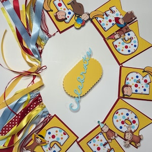 May include: A colorful birthday banner with yellow pennants, each displaying a number and a cartoon monkey. The banner includes the word "Celebrate" and is adorned with ribbons in various colors, including red, blue, and yellow. Bananas are also featured.