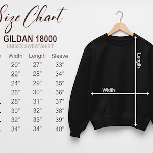 May include: A black Gildan 18000 unisex sweatshirt hangs on a wooden hanger. A size chart to the left shows measurements in inches for sizes S through 5XL. The chart includes width, length, and sleeve measurements.