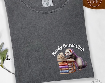 May include: A gray t-shirt with a white graphic of a ferret reading a book with the text "Nerdy Ferret Club".