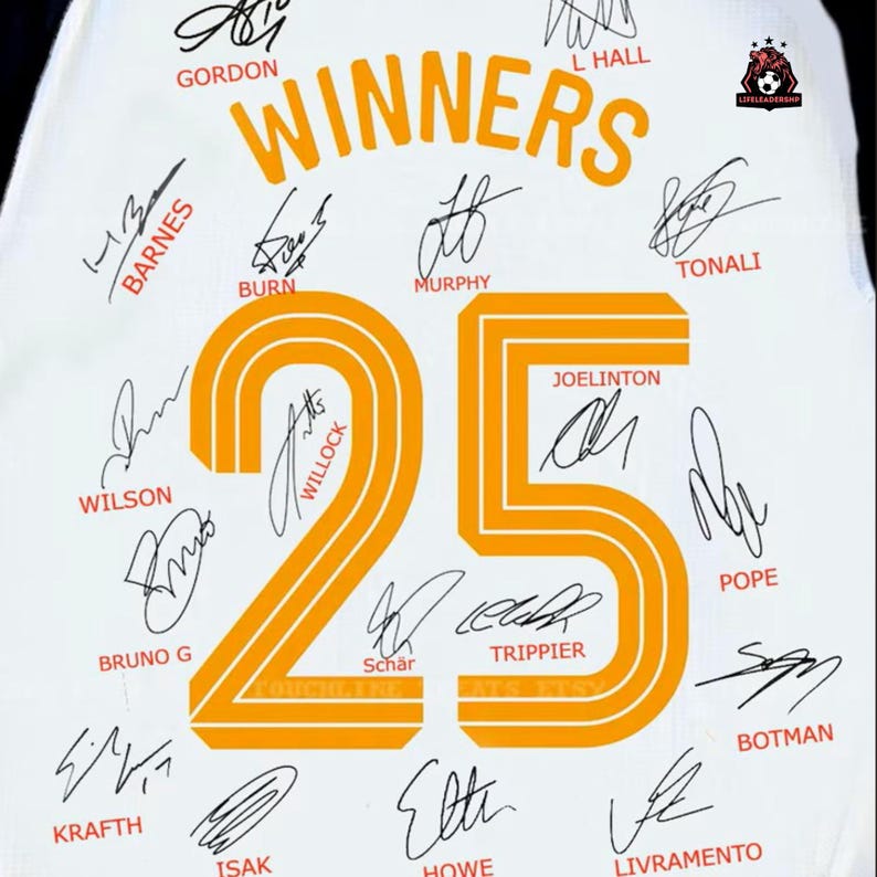 May include: White fabric with the word "WINNERS" in orange, along with the number "25" in orange. The fabric is covered with signatures in black ink. The Little Leadership logo is in the upper right corner.