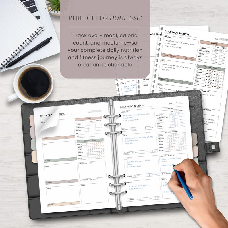 A printed daily food journal page with handwritten sample data inserted in a binder. A man's hand is shown writing on it, with a laptop, papers, and coffee cup on a desk – depicting real-life usage at home or office.