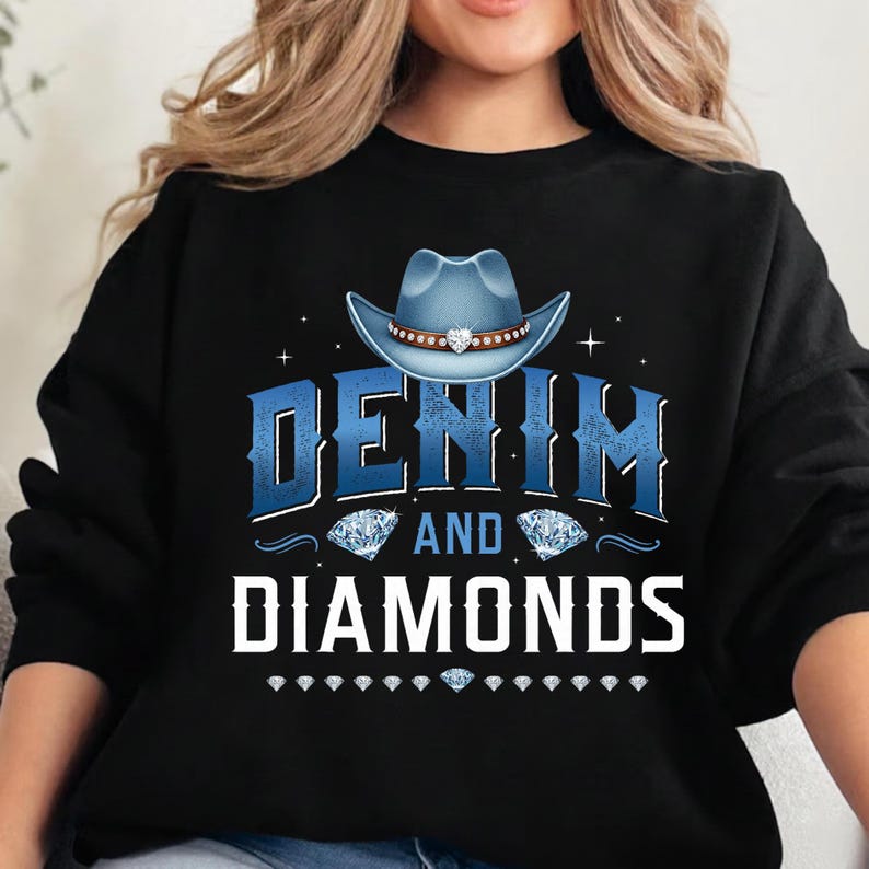 May include: Black sweatshirt with the text "DENIM and DIAMONDS" in blue and white. A blue cowboy hat with a brown band and rhinestones is above the text. Diamond graphics are also included.