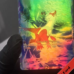 Puede incluir: Una carta coleccionable hologr&aacute;fica de Latias con la ilustraci&oacute;n de una criatura roja y blanca. La carta muestra el nombre Latias, 90 HP y el ataque Crossing Flights. El fondo tiene un efecto de luz verde y azul vibrante con palmeras.