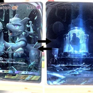 May include: Two Pokemon trading cards featuring Mewtwo. The first card shows Mewtwo in a dynamic pose with a psychic sphere effect. The second card depicts a futuristic chamber with a glowing blue interior, possibly a cloning facility.