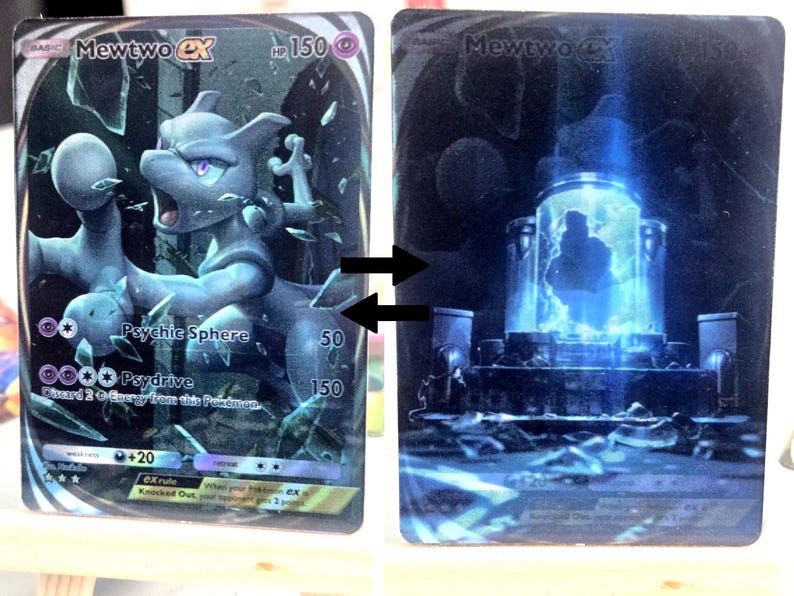 May include: Two Pokemon trading cards featuring Mewtwo. The first card shows Mewtwo in a dynamic pose with a psychic sphere effect. The second card depicts a futuristic chamber with a glowing blue interior, possibly a cloning facility.