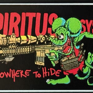 May include: Black rectangular sticker featuring a cartoon rat with a rifle and the text "SPIRITUS SYSTEMS" in red. The rat is green with a red vest and has a large, open mouth. The text "NOWHERE to HIDE" is also in red.