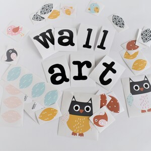 May include: A set of wall art decals featuring a variety of designs, including owls, birds, leaves, and geometric shapes. The decals are in a variety of colors, including black, white, yellow, blue, and pink. The decals are arranged in a random pattern on a white background. The text "wall art" is included in the design.