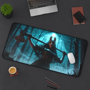 May include: A black rectangular mousepad featuring a digital illustration of a figure with a skull mask holding an axe in a dark forest setting. The color palette includes shades of blue, black, and red. A white computer mouse is on the right side.