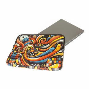 May include: A laptop sleeve with a colorful abstract design featuring swirls, geometric shapes, and a variety of colors including orange, yellow, blue, and black. A gray laptop is partially visible behind the sleeve.