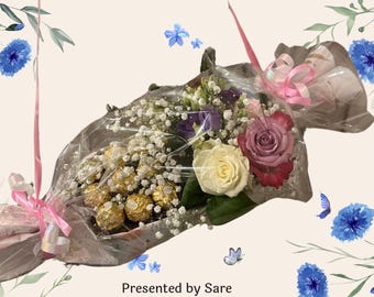 May include: A bouquet of flowers and wrapped chocolates, tied with a pink ribbon. The bouquet includes white, pink, and red roses, with baby's breath and other flowers. The background has a floral design and the text "Presented by Sare".