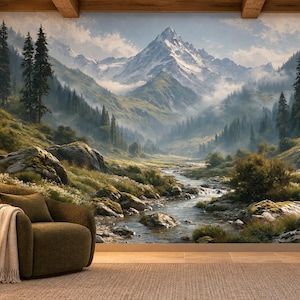 May include: A wall mural depicting a snow-capped mountain range, a flowing stream, and a dense pine forest. In the foreground, a dark olive green armchair with a white throw blanket sits next to a small wooden side table and a fireplace.