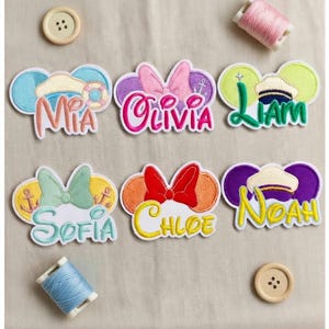 May include: A set of three ceramic mugs with a speckled, matte finish. The mugs are in shades of cream, light gray, and dark gray. Each mug has a simple, minimalist design and a rounded handle.