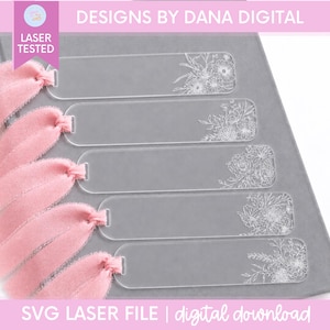 May include: Five clear rectangular acrylic bookmarks with rounded corners, each featuring a unique white floral line art design on the right side and a soft pink frayed fabric ribbon tied through a hole on the left side of each bookmark.